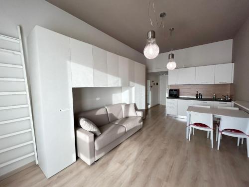 a living room with a couch and a table at Rucola Home in Castione della Presolana