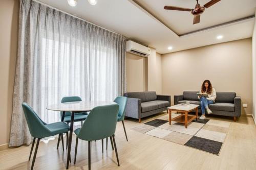 a woman sitting on a couch in a waiting room at Hotel Sukoon & Banquet Hall Near Bhopal Railway Station in Bhopal