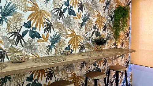 a counter with stools and plants on a wall at APARTAMENTO SOL Y PLAYA in Santa Pola