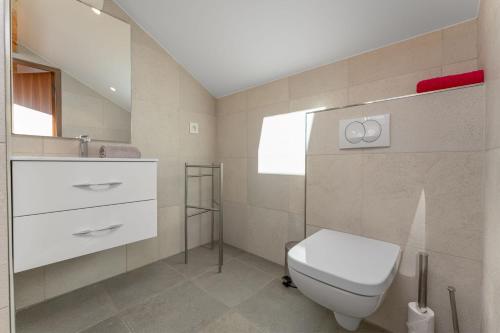 a bathroom with a white toilet and a sink at Les Sept Étoiles in Le Monêtier-les-Bains