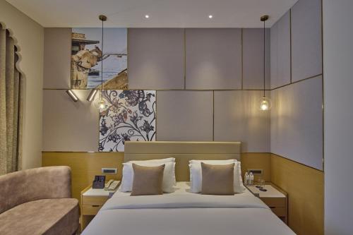 Ένα ή περισσότερα κρεβάτια σε δωμάτιο στο Grand Continent - A Luxury Collection, Udaipur