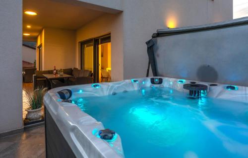 a jacuzzi tub with blue water in a room at Villa Angello in Matulji
