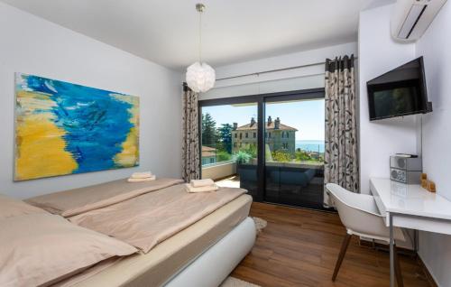 a bedroom with a bed and a desk and a window at Villa Angello in Matulji