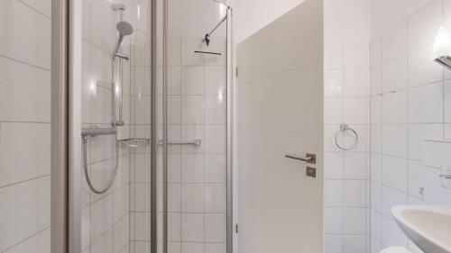 a shower with a glass door in a bathroom at Appartementhaus Binzer Sterne 23 in Binz