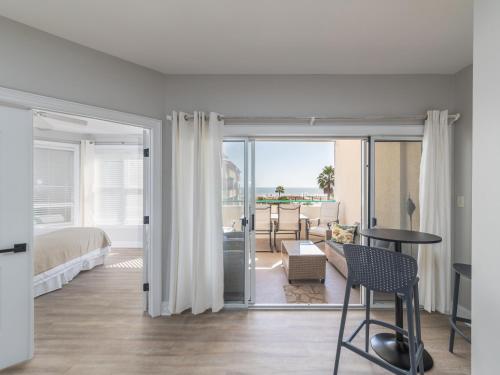 a living room with a bed and a table and chairs at Ocean Pearl in Tybee Island