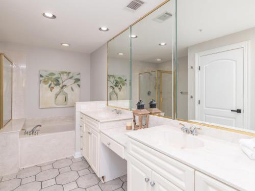 a bathroom with two sinks and a large mirror at Ocean Pearl in Tybee Island
