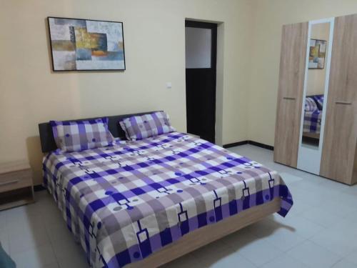 En eller flere senge i et værelse på Appartement Neuf Dakar