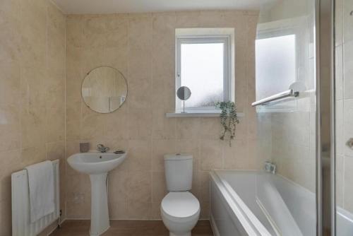 a bathroom with a toilet and a sink and a tub at Pass the Keys Seaside Sanctuary Cullercoats – Walk to the Beach in Cullercoats