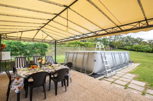 a tent with a table and chairs under it at Villa Nicola in Camaiore