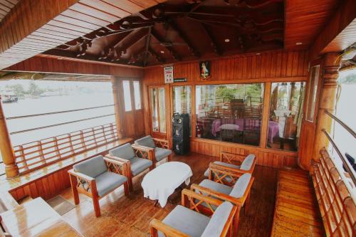 an inside view of a room with chairs and tables at JCT Exclusive 3 Bedroom Private Houseboat with All Meals in Alleppey
