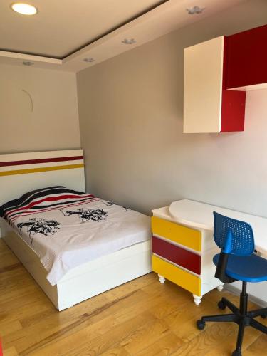 a bedroom with a bed and a desk and a chair at Detached 800 square meter villa with forest view in the city in Pamukkale