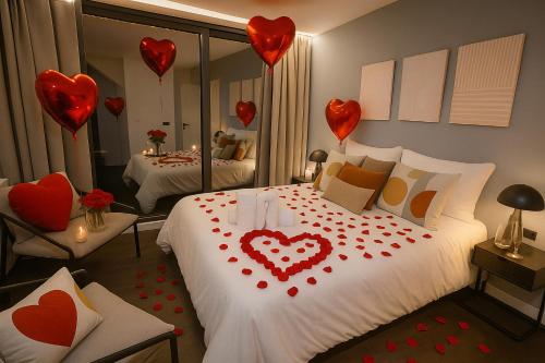 a room with a bed with hearts on it at La Suite Secreta del Júcar in Alcalá del Júcar