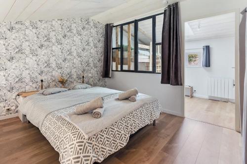 a bedroom with a bed and a large window at La Rousseline - Bord de Sèvre, Calme & Moderne in Boussay