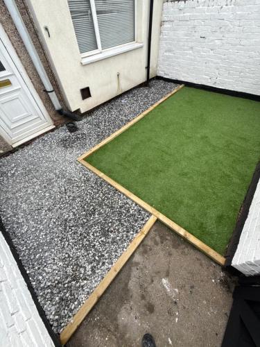 a yard with a green lawn next to a door at ResiLets Taylor House in Bebside