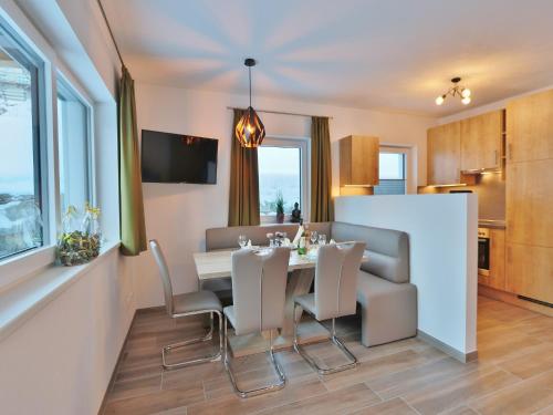 a kitchen and dining room with a table and chairs at Apartment in Piesendorf near Ski Slopes in Piesendorf