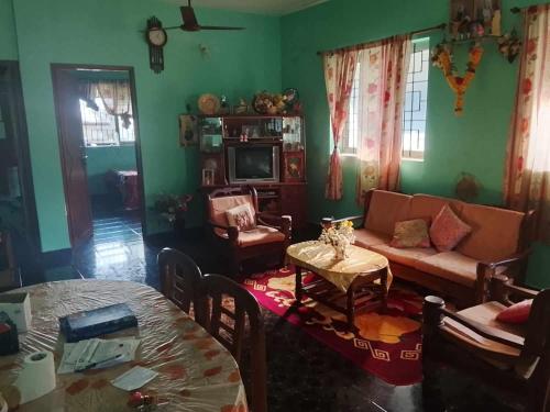 a living room with a couch and a table at Noah Yourt in Siolim