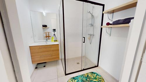 a bathroom with a glass shower and a sink at Casa 3 Merlyne Plage in Saint-Gilles-Croix-de-Vie