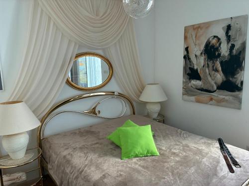 a bedroom with a bed with a green pillow on it at Perla & Palma in Zaboric