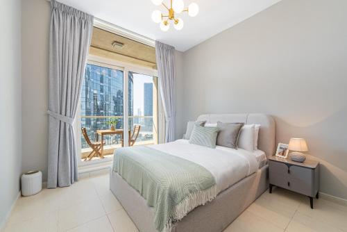 a bedroom with a bed and a large window at Urban Chic - Mangrove Place in Abu Dhabi