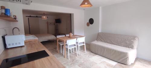 a living room with a couch and a table at Le Laoul cottage 2 people in Bourg-Saint-Andéol