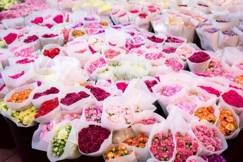 a bunch of different types of flowers in baskets at Wat We See Bangkok Hostel in Bangkok