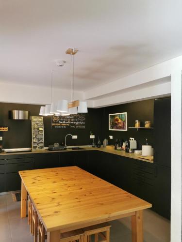 a kitchen with a wooden table in a kitchen at Globo Happy Hostel in Angra do Heroísmo