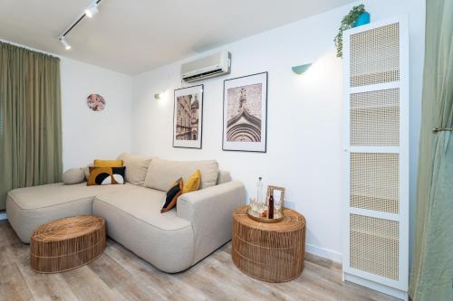 a living room with a couch and two tables at Villa LaPetra in Cavtat