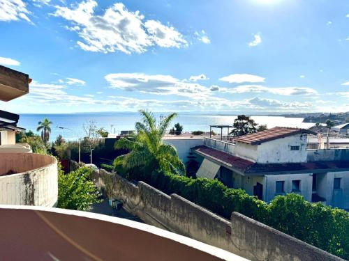 a view of the ocean from the balcony of a house at Marilù e il Mare - Your home by the sea in Aci Castello