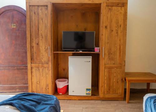 a room with a small refrigerator and a tv at yasmina hotel in Dahab