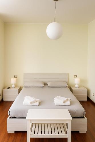 a white bedroom with a bed and two night stands at Residenza la Sapienza in Viterbo