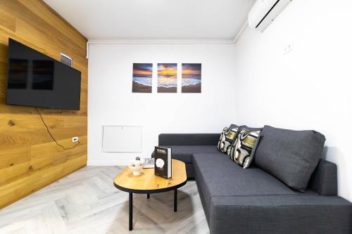 Popeşti-LeordeniにあるAmaria Sunsetのソファとテーブルのあるリビングルーム