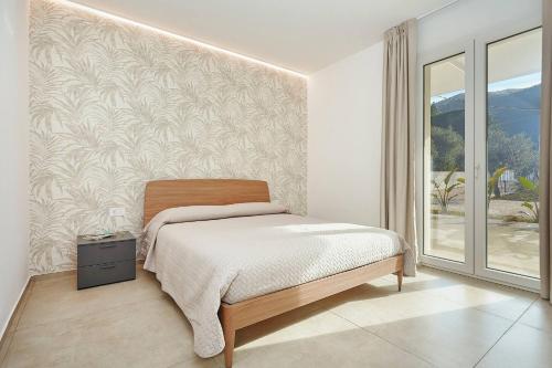 a bedroom with a bed and a wall at Villa the Twins in Castellammare del Golfo
