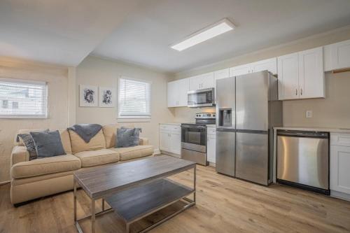 a living room with a couch and a table at Caras Cottage - 2 miles from Sanford Stadium in Athens