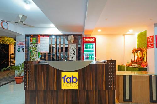 a fast food restaurant with a sign on the counter at FabHotel Club Metro in Nagpur