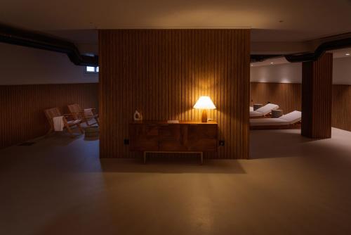 a room with a table with a lamp on it at Porto Cabana by Miramar Stays in Cabana de Bergantiños