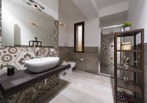 a bathroom with a sink and a toilet at La Suite Di Tyche in Castellammare del Golfo