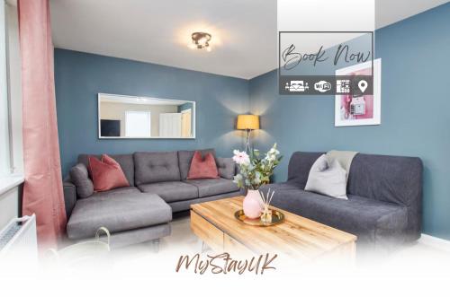 a living room with a couch and a table at Spacious, 3BR, Coventry House | Sleeps 9 | Parking in Canley