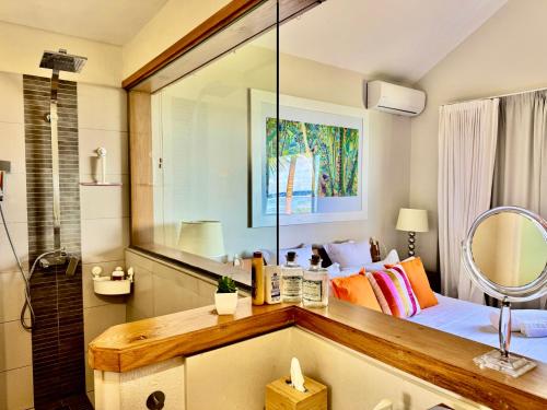 a bedroom with a bed with a large mirror at SG17 Villa Sable Front de Mer in Palmar