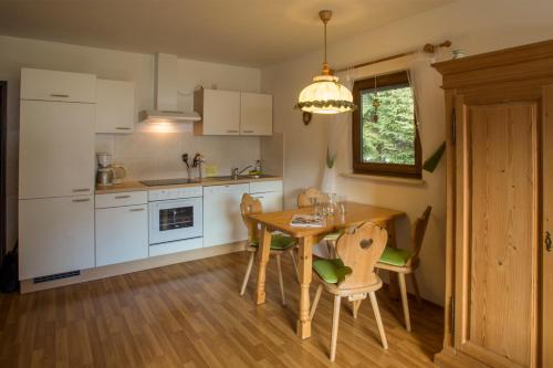 a kitchen with a table and chairs and a dining room at Zugspitz Traumapartment in Farchant