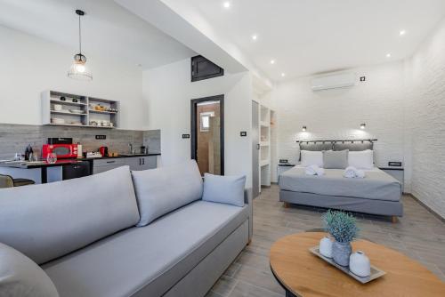 a living room with a couch and a bed at Seaside Suite in Galissas