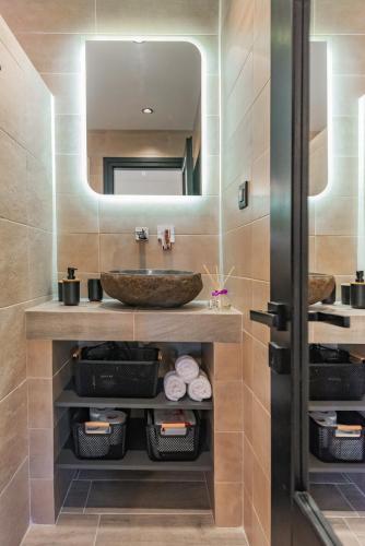 a bathroom with a sink and a mirror at Seaside Suite in Galissas