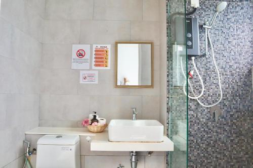 a bathroom with a sink and a shower at The Shore LW Premium Suites KK Downtown in Kota Kinabalu