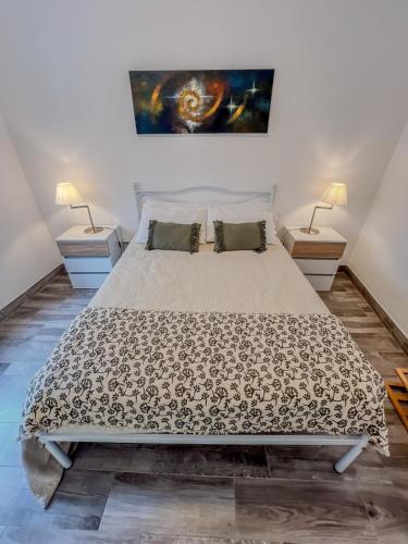 a bedroom with a large bed with two night stands at Casa Passa Tempo in Aldeia do Mato