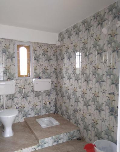 a bathroom with a sink and a toilet at Backpackers' Haven in Guwahati