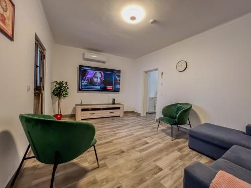 a living room with a couch and a tv at Casa Passa Tempo in Aldeia do Mato