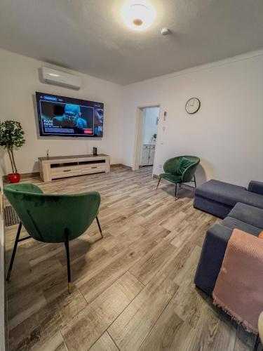 a living room with a couch and a tv at Casa Passa Tempo in Aldeia do Mato