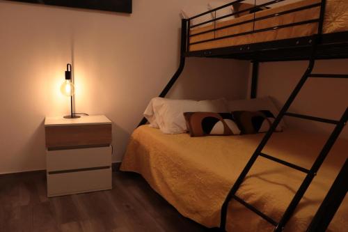 a bedroom with a bunk bed and a lamp at Casa Passa Tempo in Aldeia do Mato