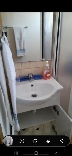 a bathroom with a white sink and a mirror at Vista Clara in Ponta do Sol