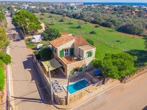 an overhead view of a house with a swimming pool at Villa Sa Llimonera by Slow Villas in Cala Llombards