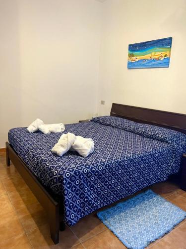 a bedroom with a bed with towels on it at La Pavoncella Holiday Home in San Vito
